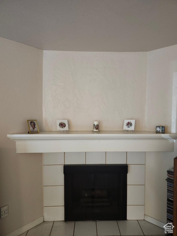 Detailed view of a fireplace and baseboards