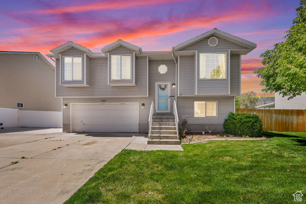 View of front of property with an attached garage and driveway