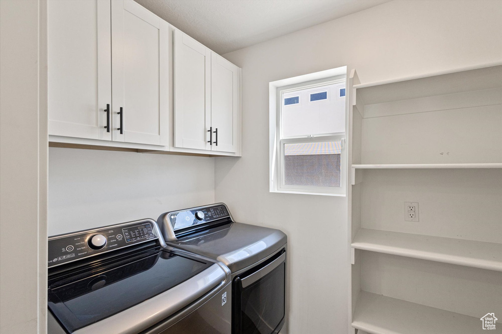 Laundry room featuring washer and dryer and cabinet space