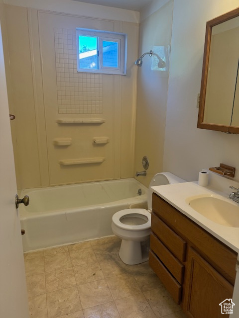 Full bathroom featuring vanity, shower / bath combination, and toilet