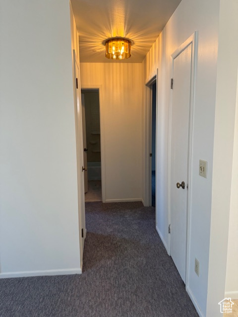 Hall with carpet floors and baseboards
