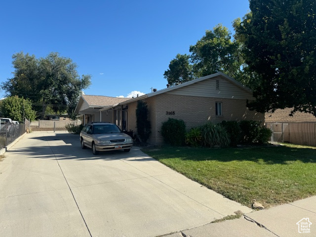 View of front of property with concrete driveway and brick siding