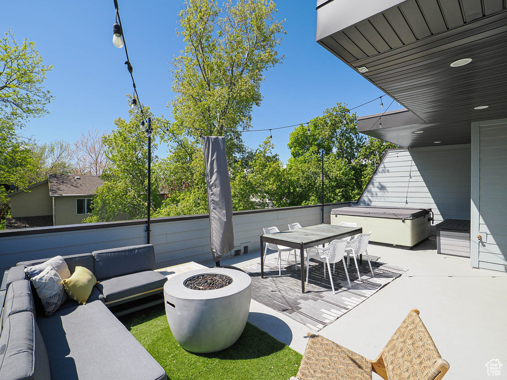 View of patio / terrace with an outdoor living space with a fire pit and outdoor dining space