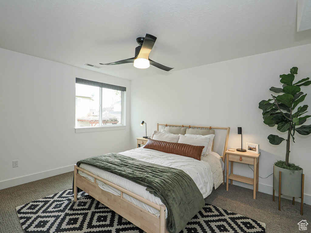 Bedroom with carpet floors, baseboards, and ceiling fan