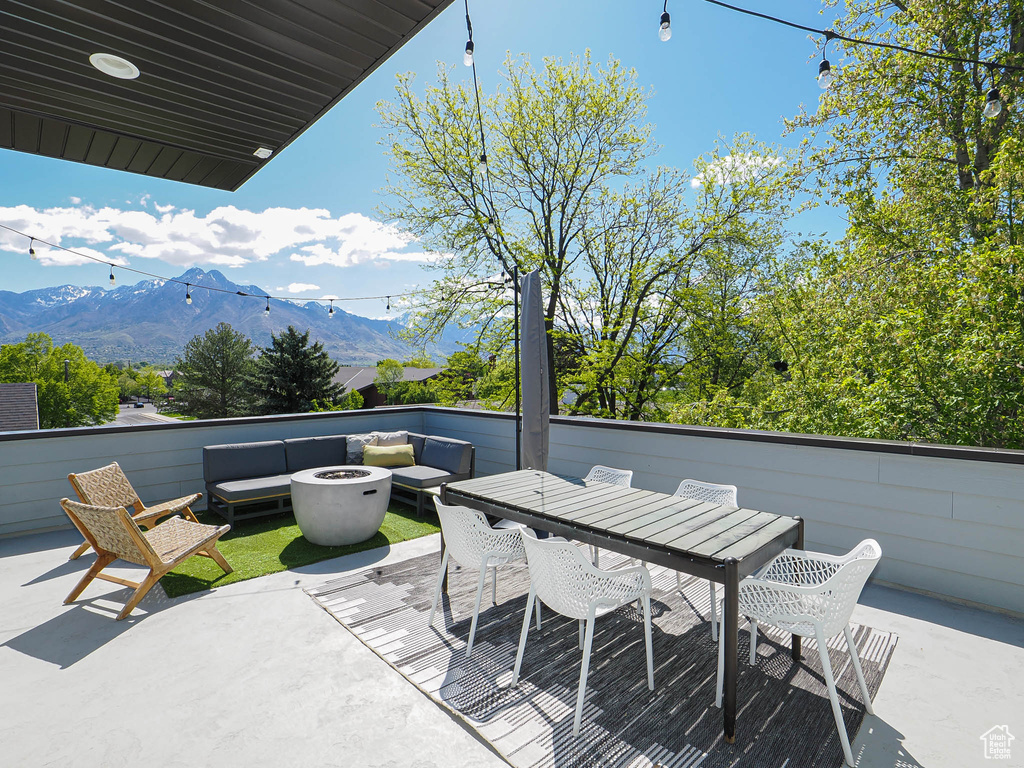 View of patio featuring a mountain view and an outdoor fire pit