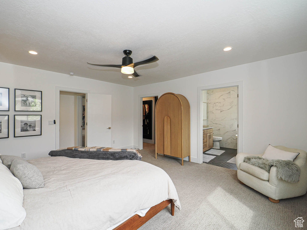 Carpeted bedroom with connected bathroom, recessed lighting, ceiling fan, and baseboards