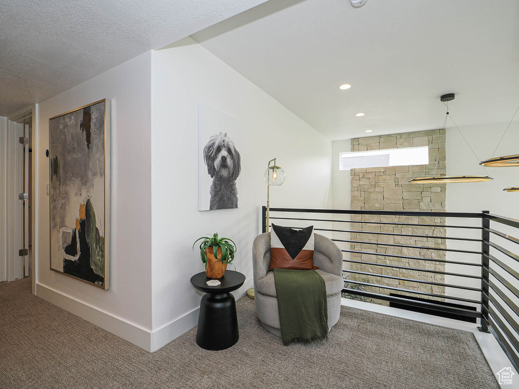 Living area featuring an upstairs landing, carpet floors, recessed lighting, and baseboards