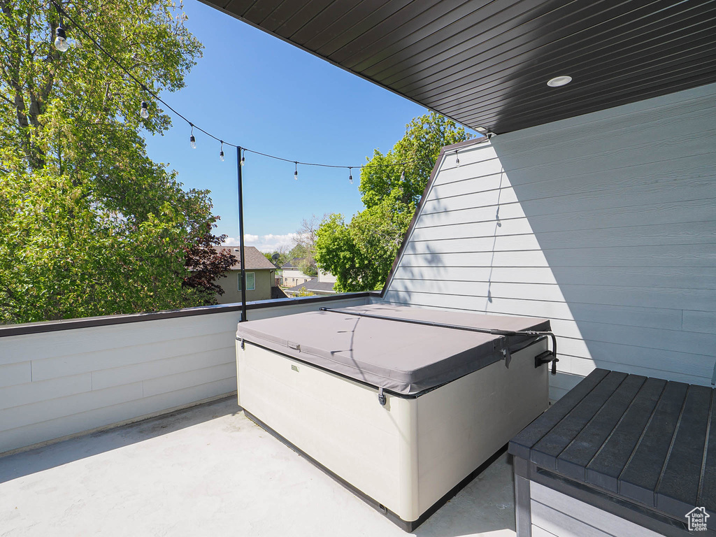 Balcony featuring a hot tub and a patio area