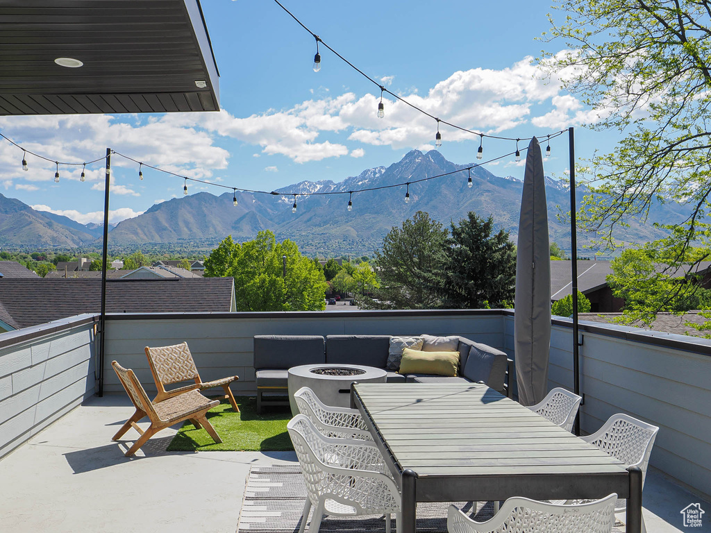 View of patio / terrace with a fire pit and a mountain view