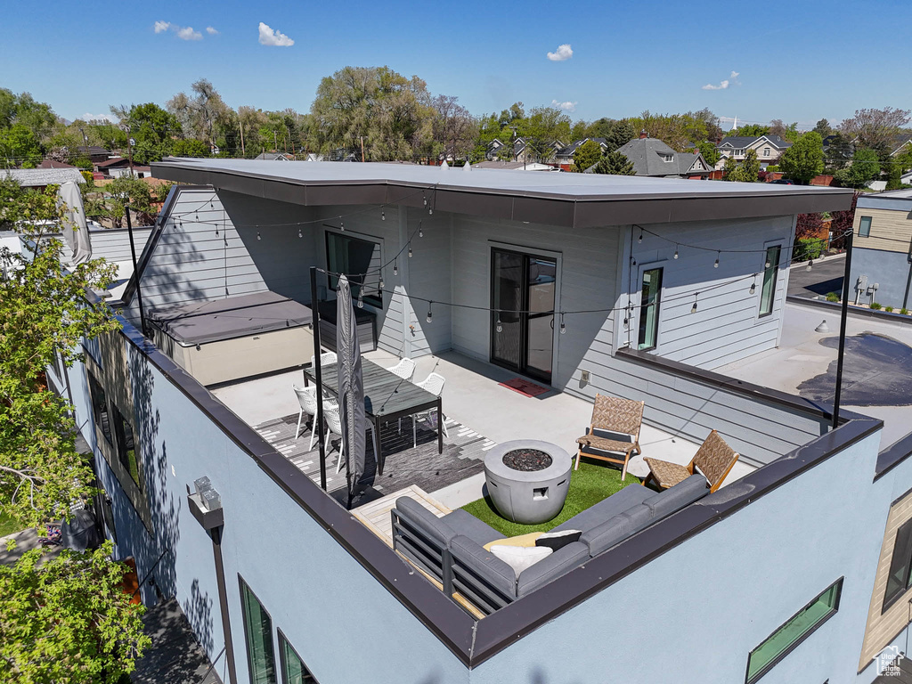 Back of house with an outdoor fire pit and a patio area