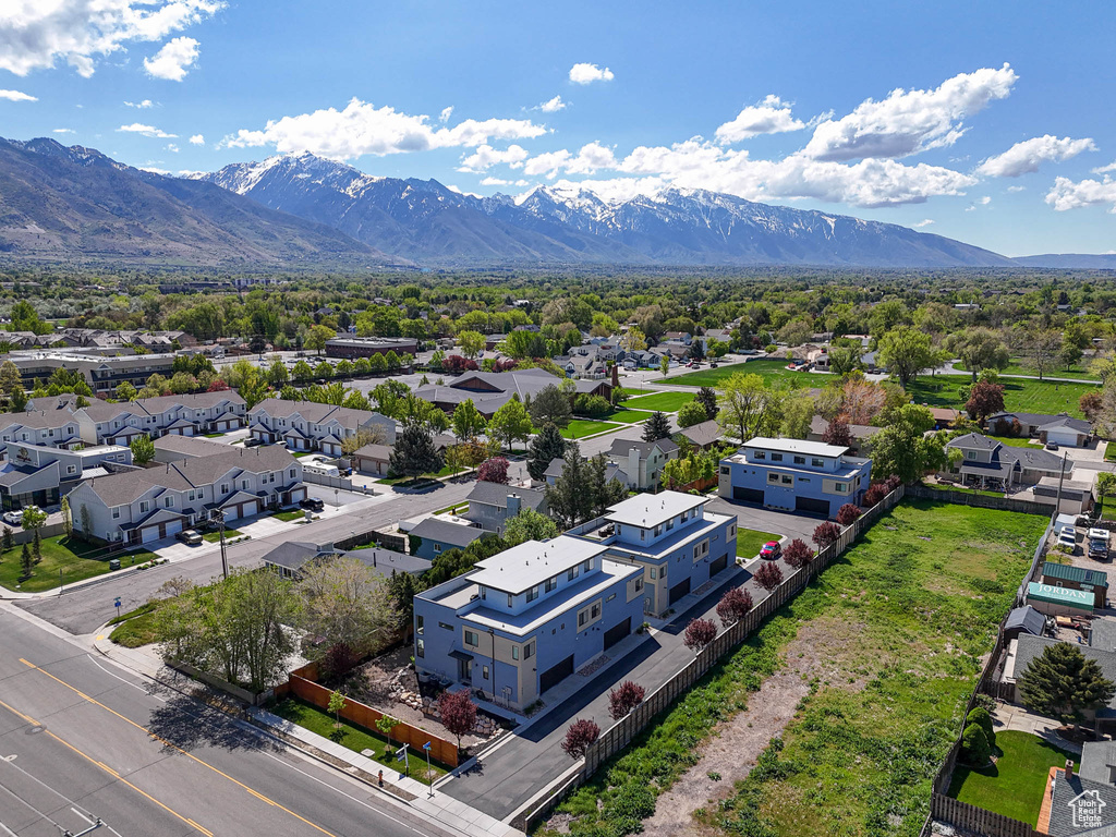 Aerial perspective of suburban area featuring a mountainous background
