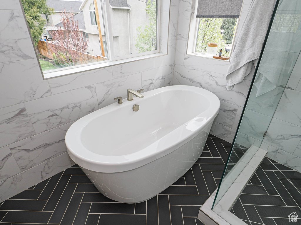 Bathroom with tile walls and a freestanding bath
