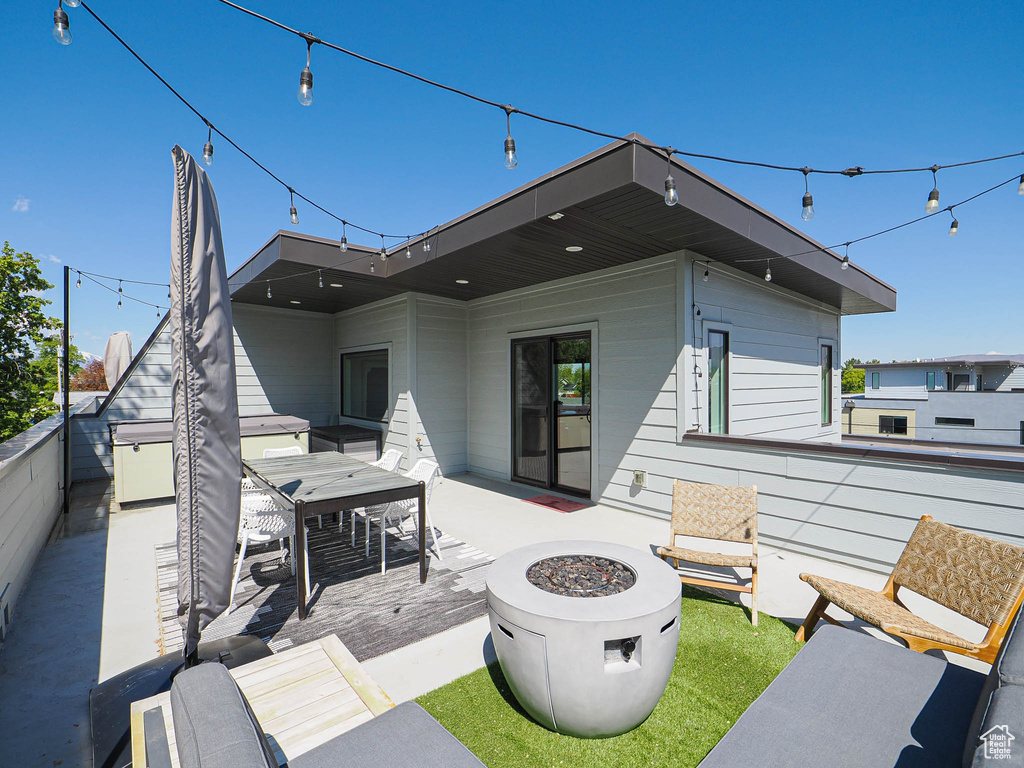 View of patio / terrace with a fire pit and outdoor dining area