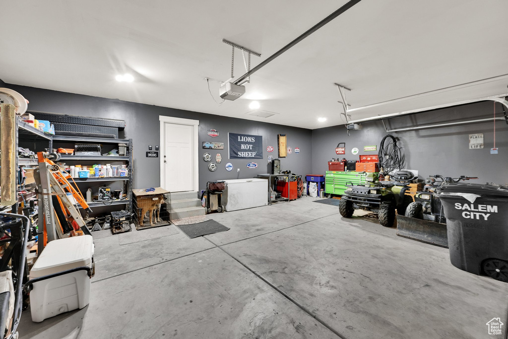 Garage with a workshop area and a garage door opener