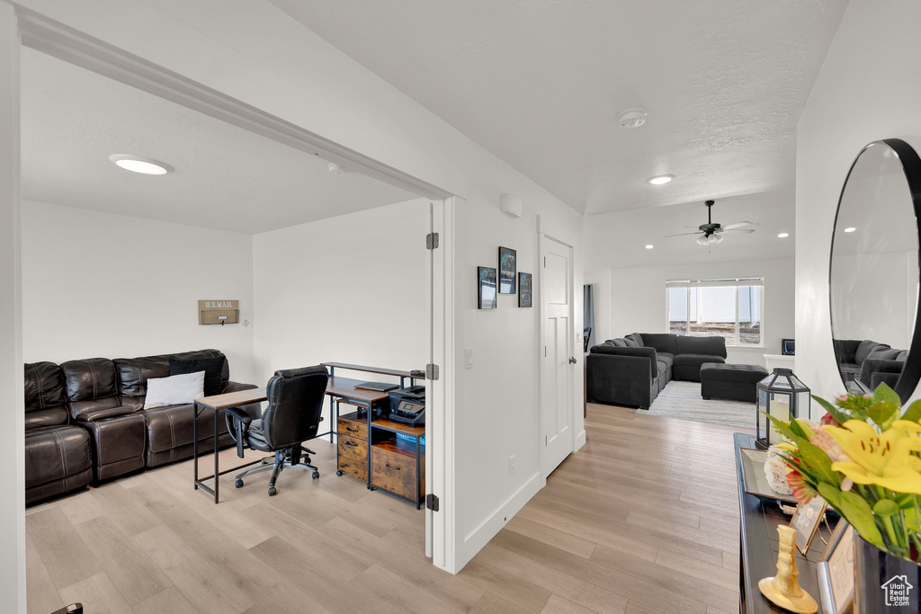 Home office with light wood-style floors, ceiling fan, and recessed lighting