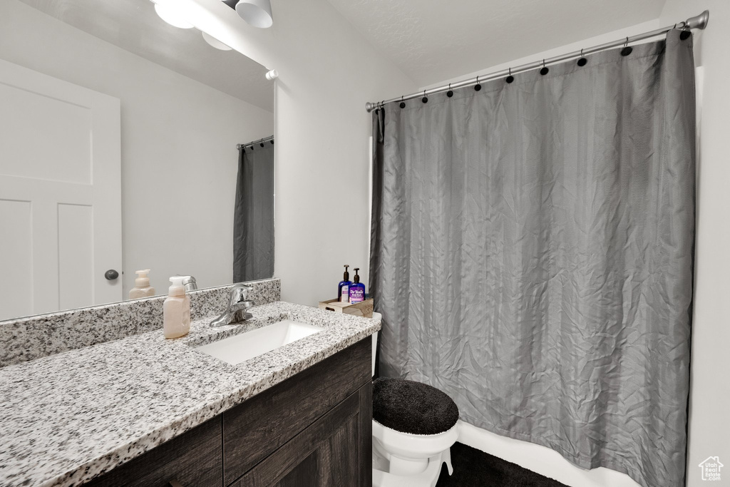Full bath with toilet and vanity
