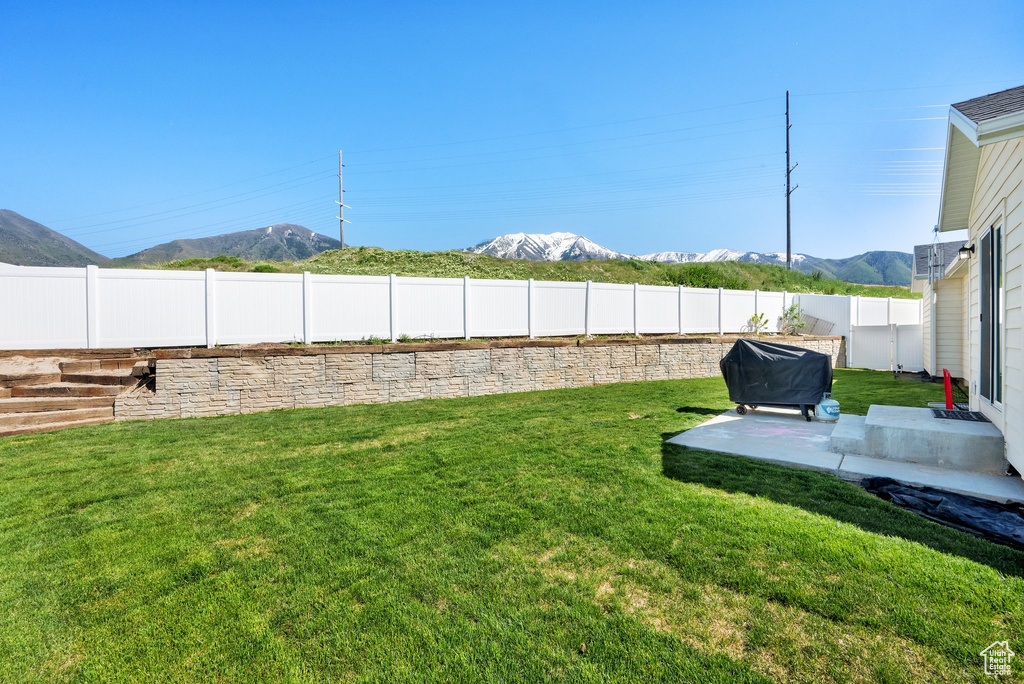 View of yard with a mountain view and a patio