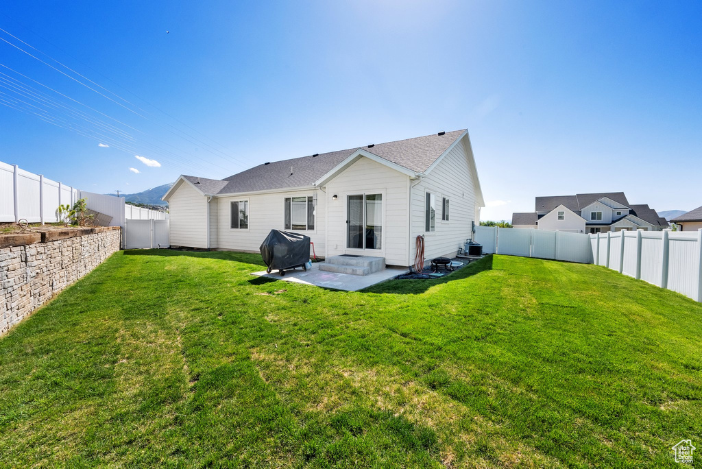 Rear view of property featuring a patio