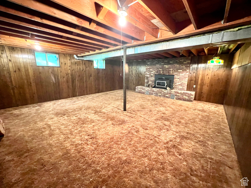 Basement with wooden walls and carpet floors