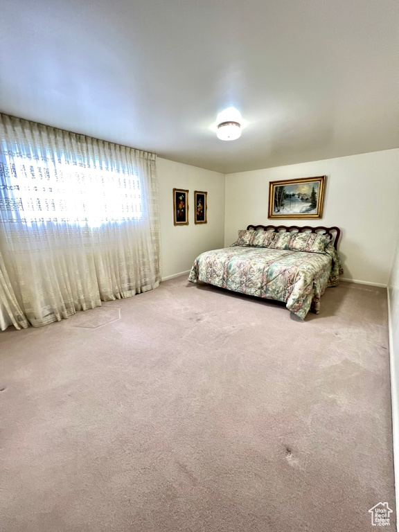 Carpeted bedroom featuring baseboards