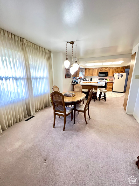 Dining room featuring light colored carpet