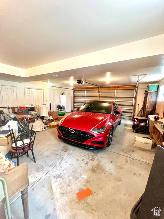 Garage featuring a garage door opener