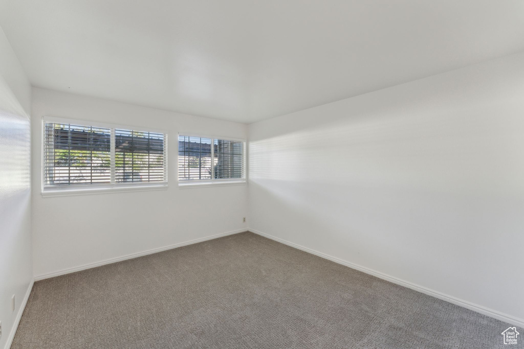 Carpeted spare room with baseboards