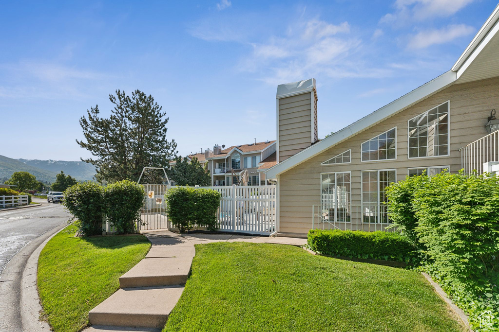 View of yard featuring a mountain view and a gate