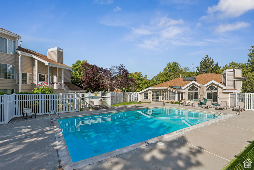Community pool featuring a patio