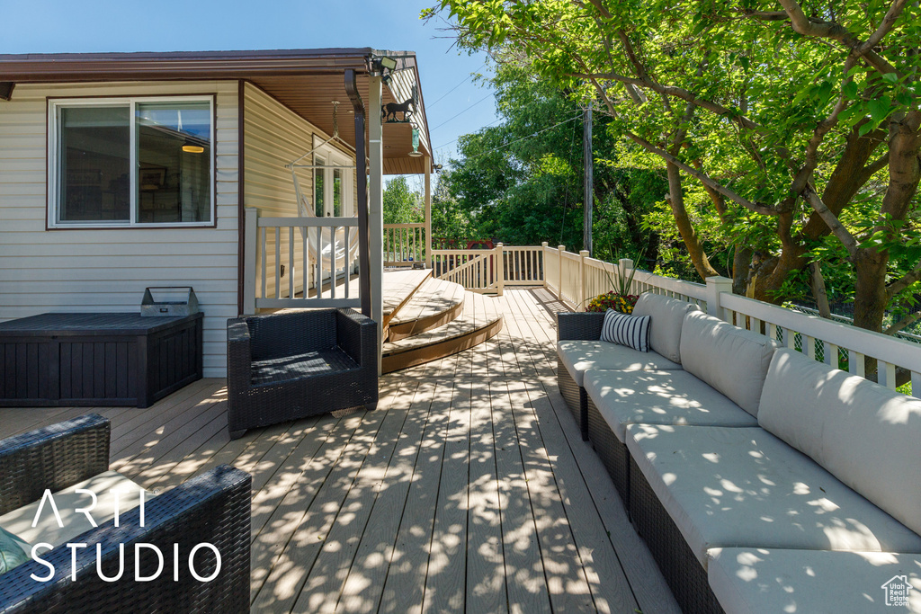 Wooden deck featuring an outdoor living space