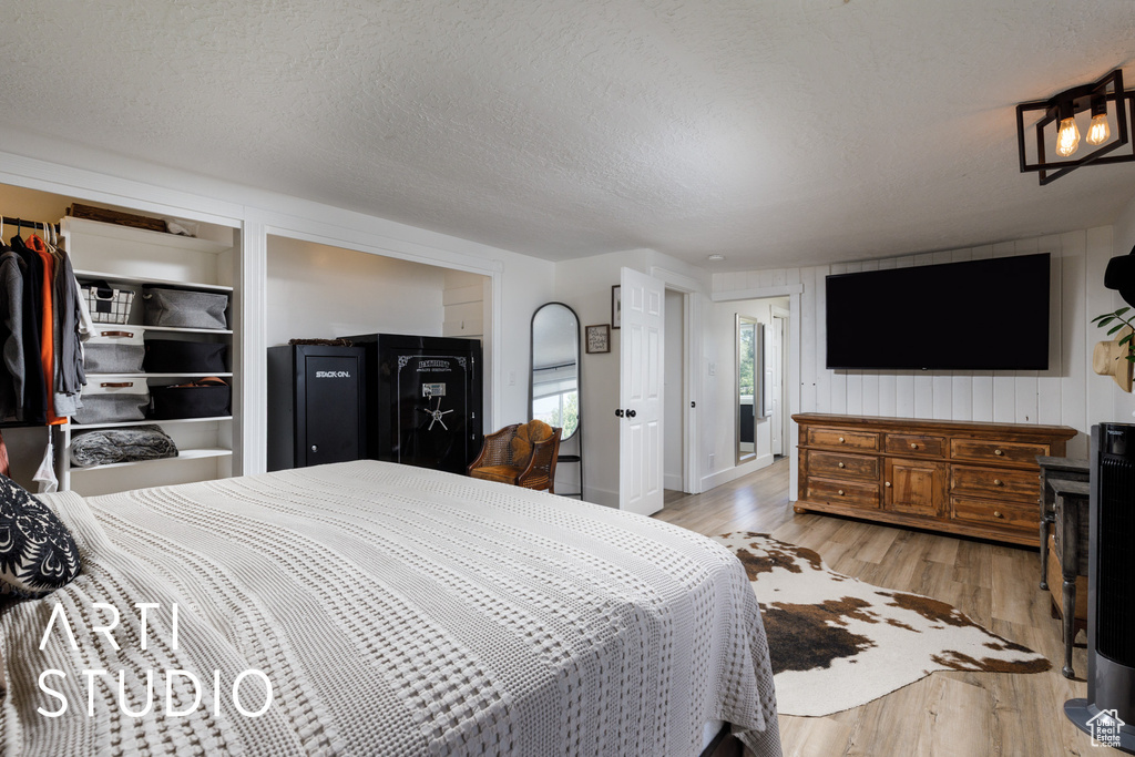 Bedroom featuring light wood-type flooring and a textured ceiling