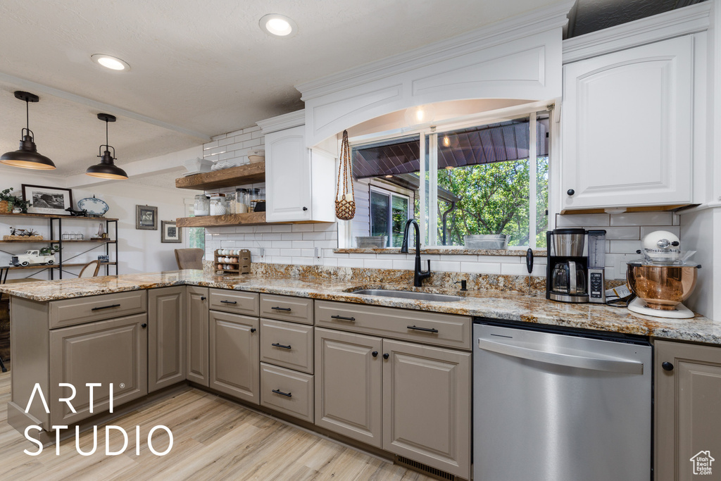 Kitchen featuring dishwasher, a sink, gray cabinets, open shelves, and decorative backsplash