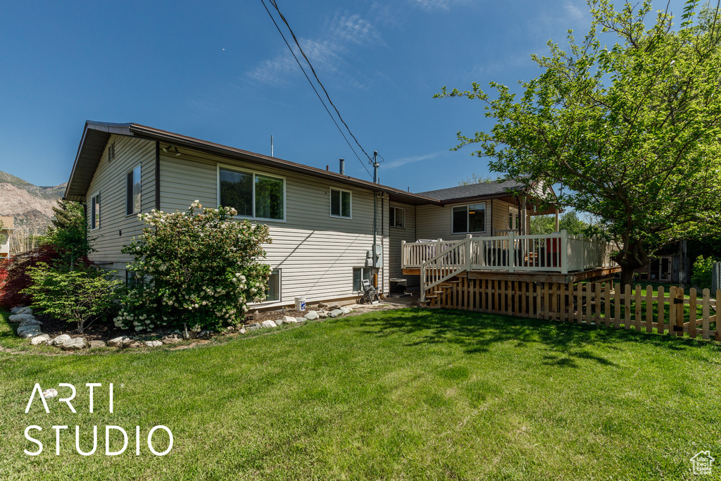 Rear view of property with a wooden deck