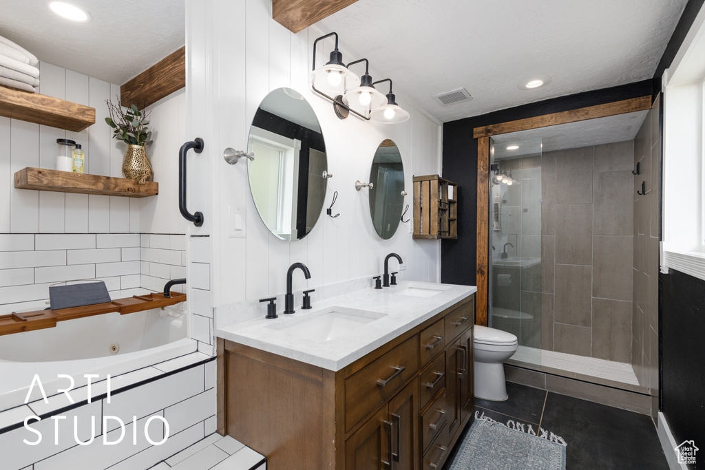Full bath with double vanity, a whirlpool tub, a stall shower, tile patterned floors, and toilet