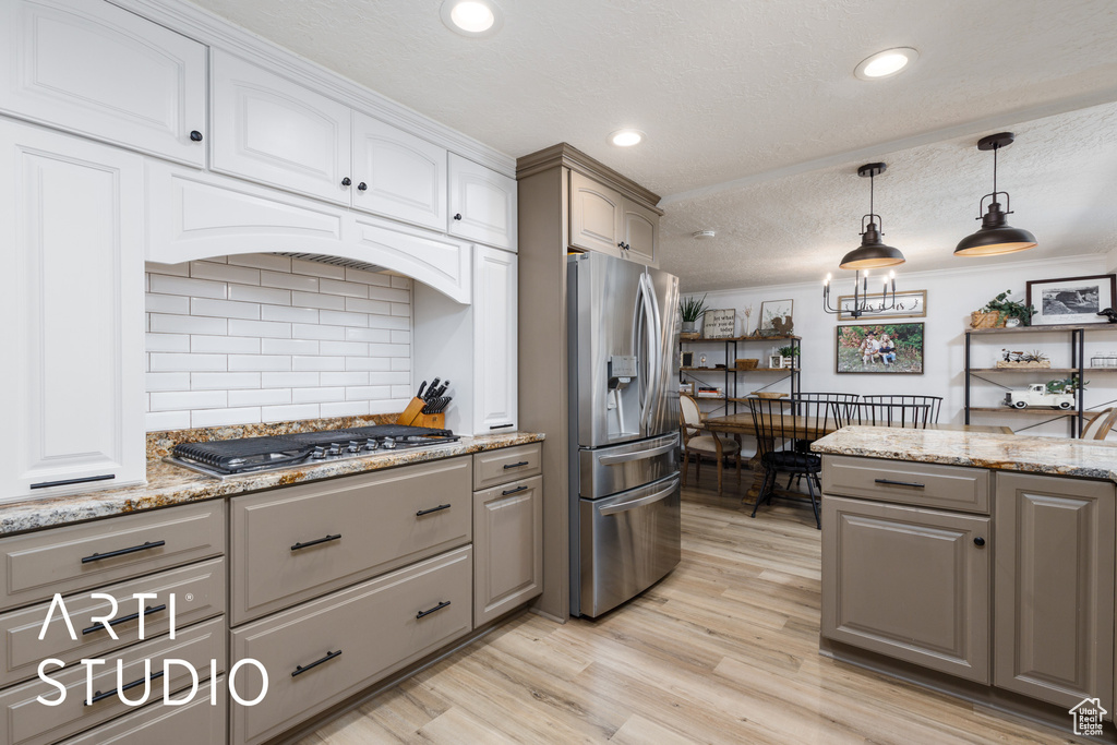 Kitchen with stainless steel appliances, gray cabinets, light wood-type flooring, recessed lighting, and a textured ceiling