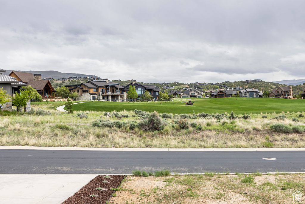 View of asphalt street featuring a residential view and a mountain view