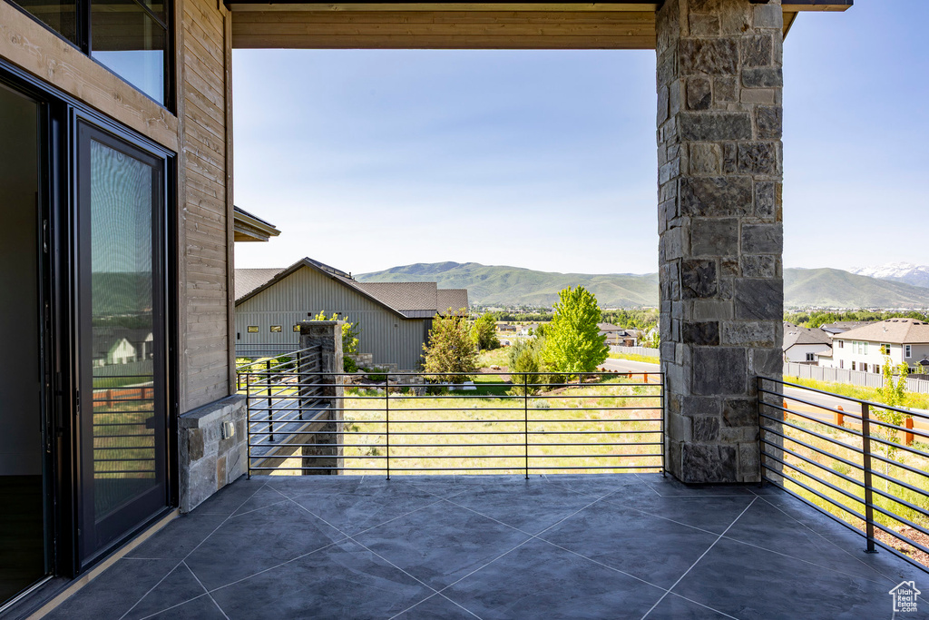 View of patio / terrace with a mountain view and a balcony