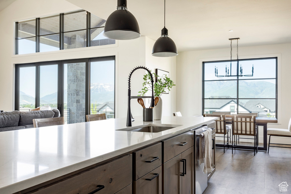 Kitchen with a sink, plenty of natural light, a chandelier, and hanging light fixtures