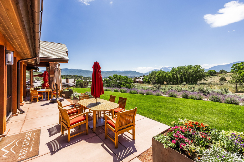 View of patio / terrace featuring a mountain view and outdoor dining area