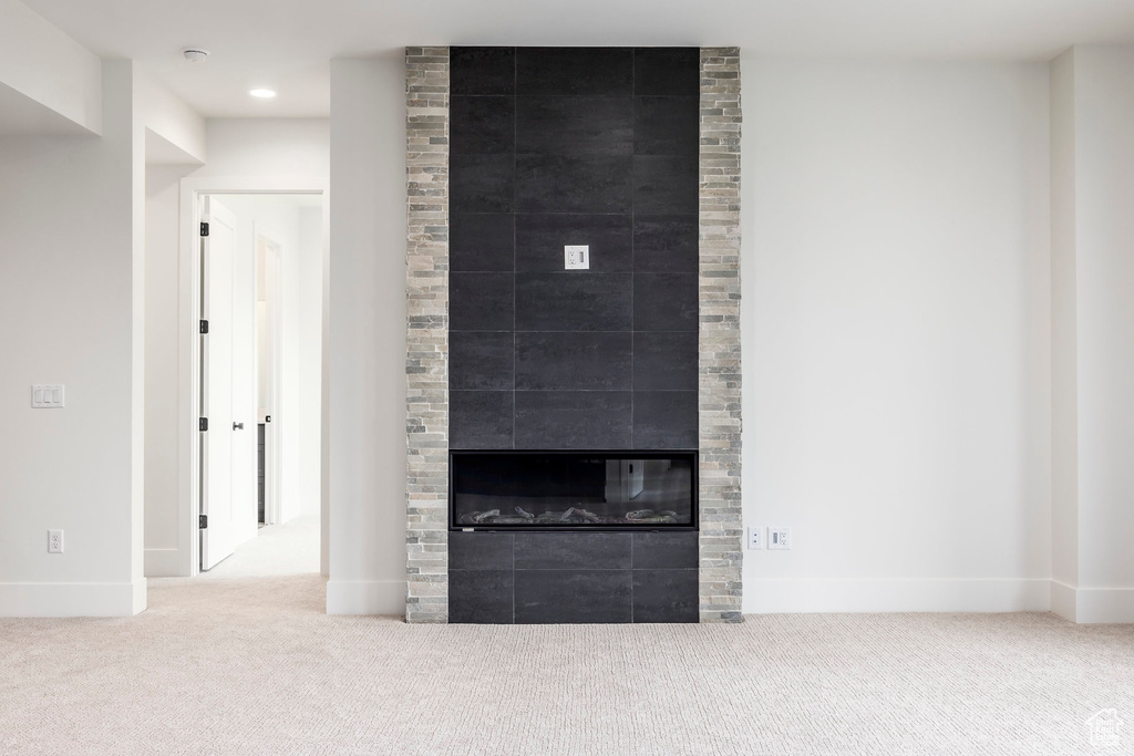 Detailed view of carpet flooring, baseboards, a fireplace, recessed lighting, and a smoke detector