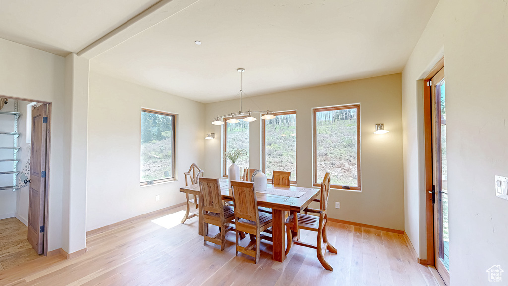 Dining area with light wood-style floors and baseboards