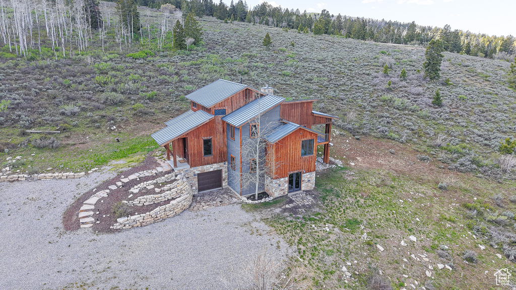 View of outdoor structure featuring an attached garage and driveway