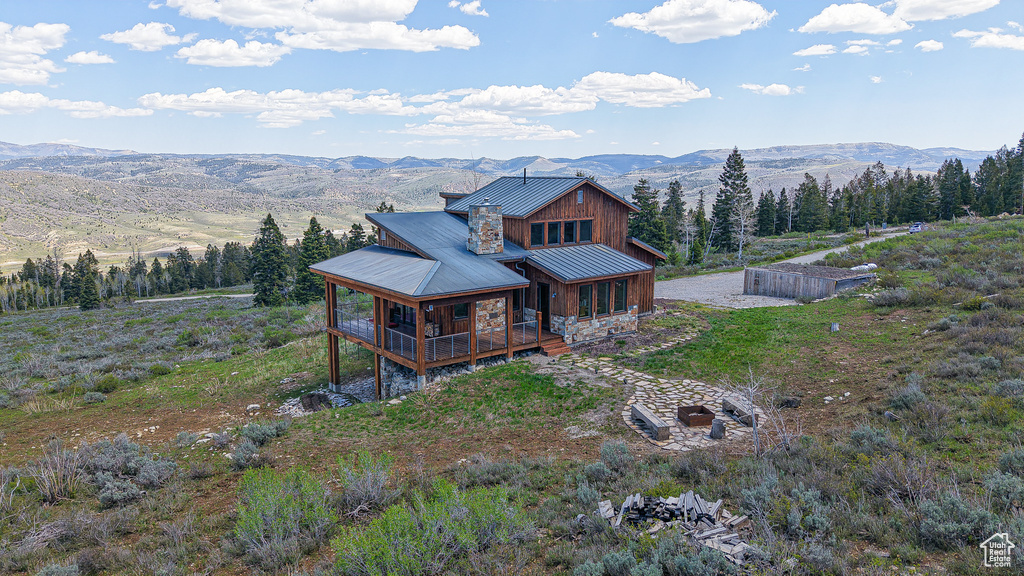 View of front of house featuring a mountain view, metal roof, a standing seam roof, board and batten siding, and covered porch