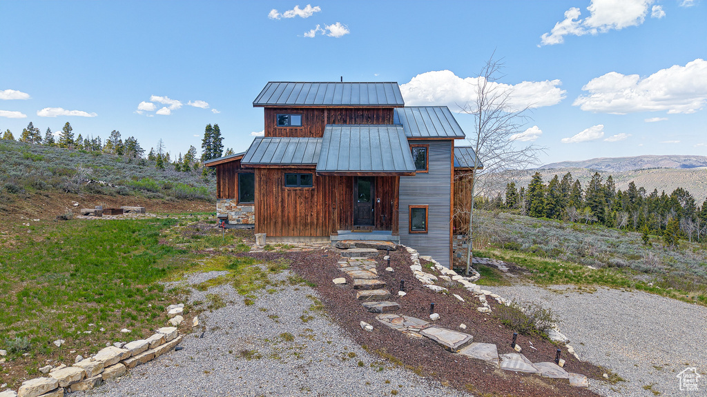 View of front of property featuring a standing seam roof, metal roof, and a mountain view