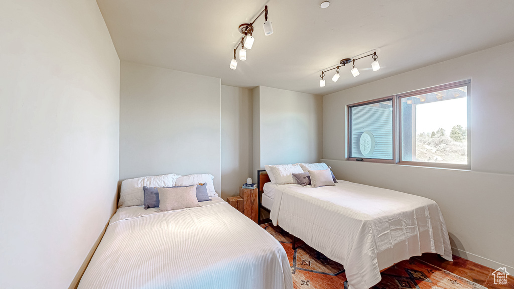 Bedroom featuring wood finished floors and baseboards