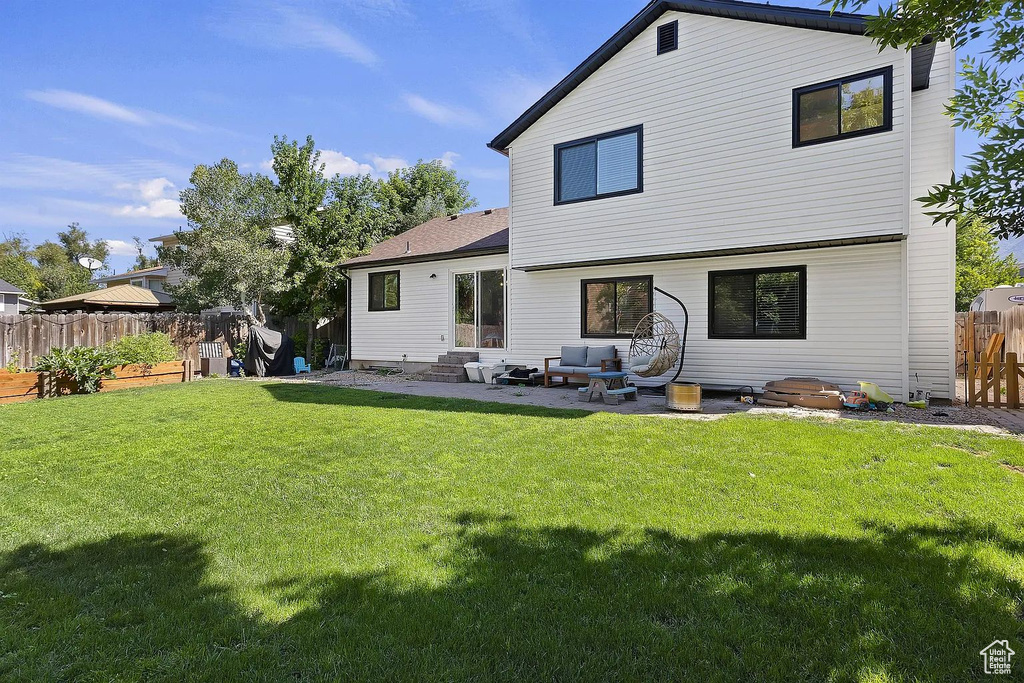 Rear view of property with an outdoor living space and a patio area