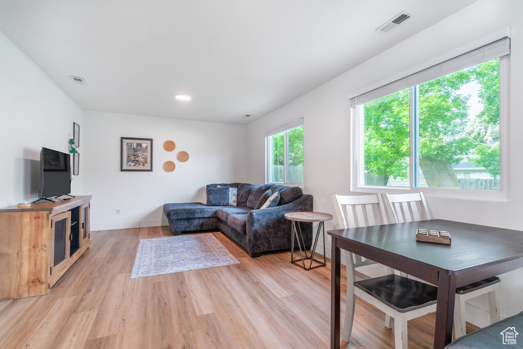 Living area featuring light wood-style flooring and baseboards