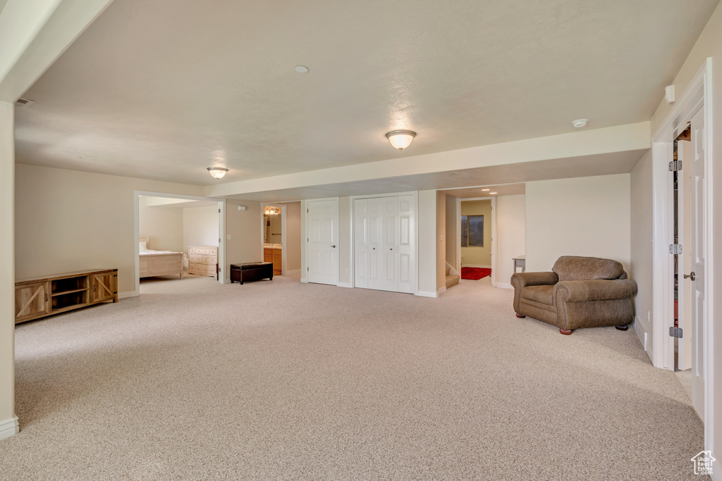 Living area featuring carpet floors and baseboards