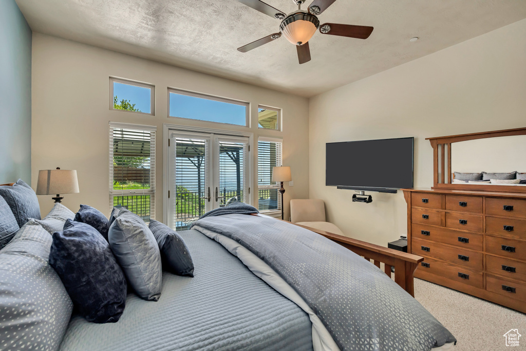 Bedroom featuring access to outside, carpet flooring, and ceiling fan