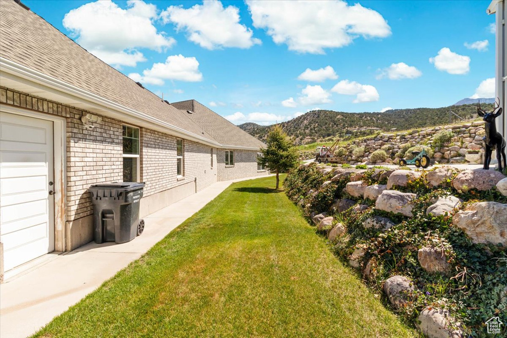 View of green lawn featuring a mountain view